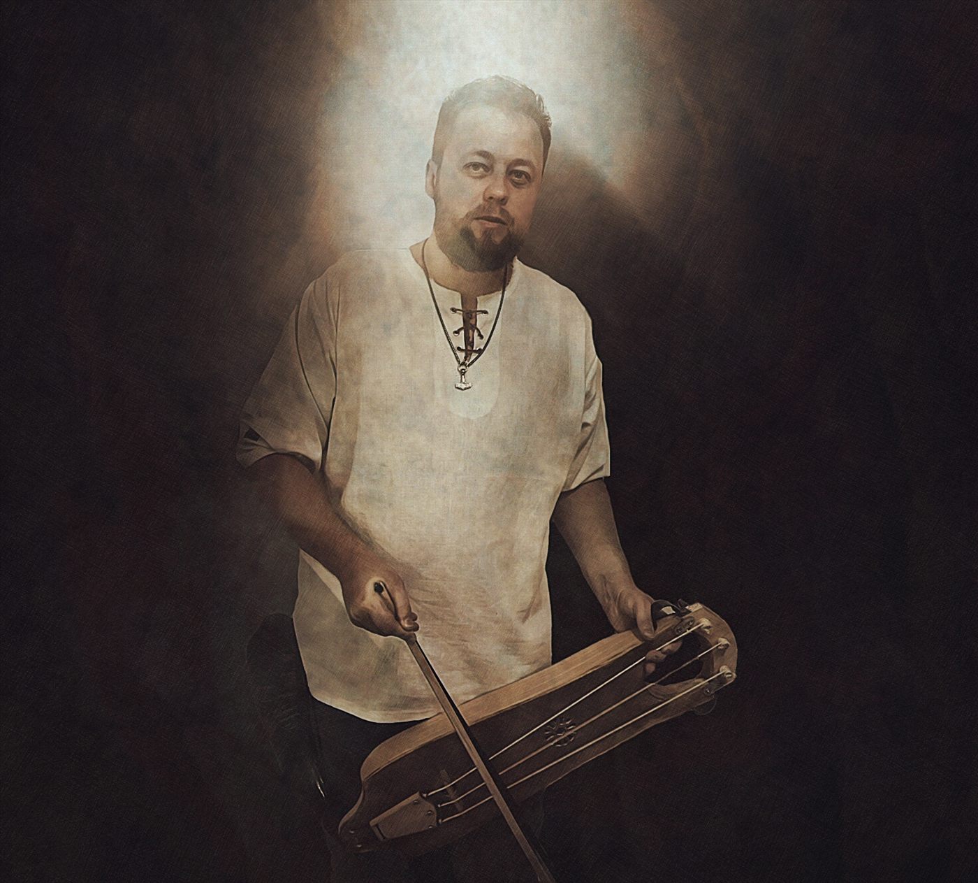 Danheim playing the bowed tagelharpa, lit by firelight